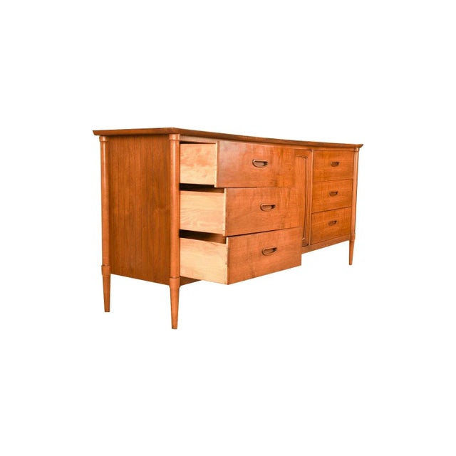 A classic Mid Century Modern walnut dresser or sideboard by Lane Furniture Company. This vintage walnut dresser features a...