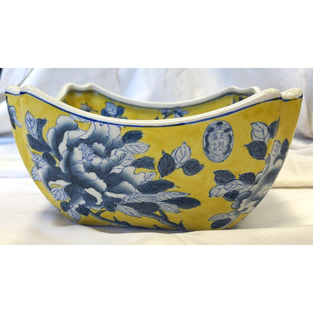Stylish vintage blue and yellow ceramic bowl. The heavy ceramic piece is made in a handkerchief-like shape with...