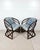 Vintage pair of round back rattan lounge chairs. Curved frames with bent rattan details. Upholstered seats with removable...