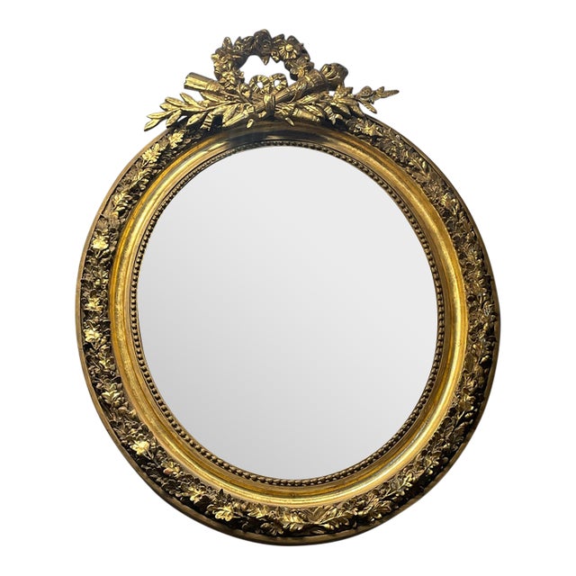 French-Inspired Oval Wall Mirror – Ornate Gold Leaf Frame With Sculpted Laurel Wreath Crest For Sale