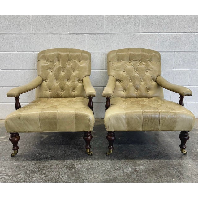 George Smith Edwardian Style Chairs in a muted olive green tone tufted leather on turned mahogany legs with brass casters....