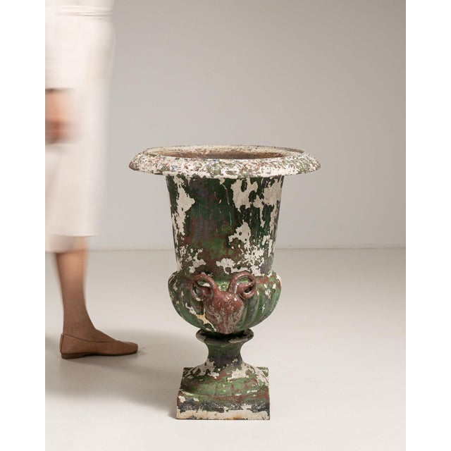 This urn carries genuine presence, its green/black weathered cast iron, campana form on plinth immediately setting the...