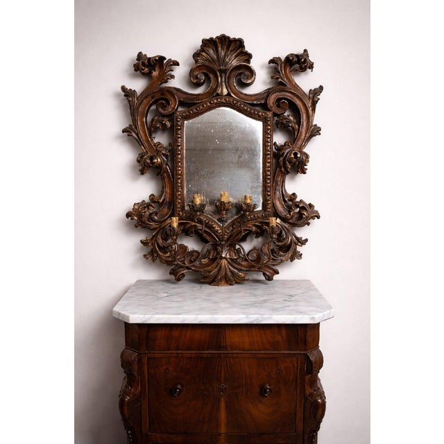 Large Venetian wall mirror in the Louis XV style with five carved wooden arms, richly decorated with rocaille and foliate...