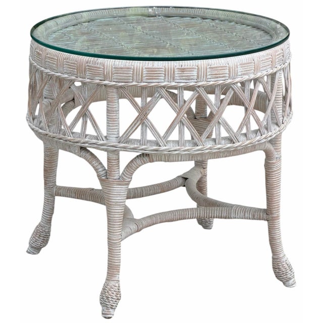 Beautiful vintage whitewashed rattan petite center table featuring an intricately woven frame with lattice detailing,...