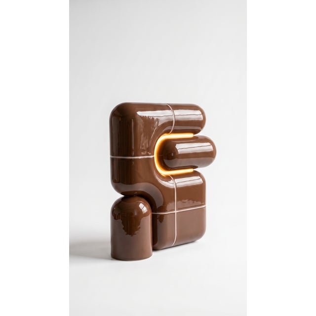 The smallest lamp in the collection, and often the first one people reach for. Its folded form hides the source entirely,...