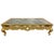 A striking Rococo-style giltwood coffee table featuring an inset antiqued mirrored top framed by a molded gilt edge. The...