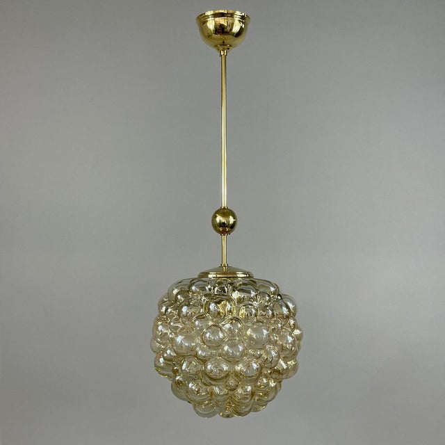 This mid-century pendant was designed and manufactured in germany in the 1960s by glashütte limburg. The light features a...