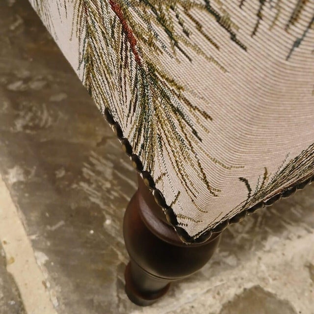 Meticulously handcrafted in the United Kingdom, this upholstered stool boasts classic studding and hand-polished solid...