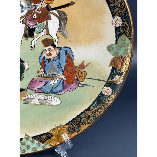 A unique large porcelain Japanese dish with an original design. The platter depicts a hunter, a sage, an artisan and a...