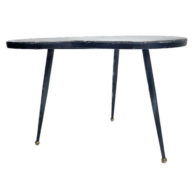 Mid-Century Modern style marble kidney shape side table with tapered leg metal base and brass ball feet. Marble is made of...