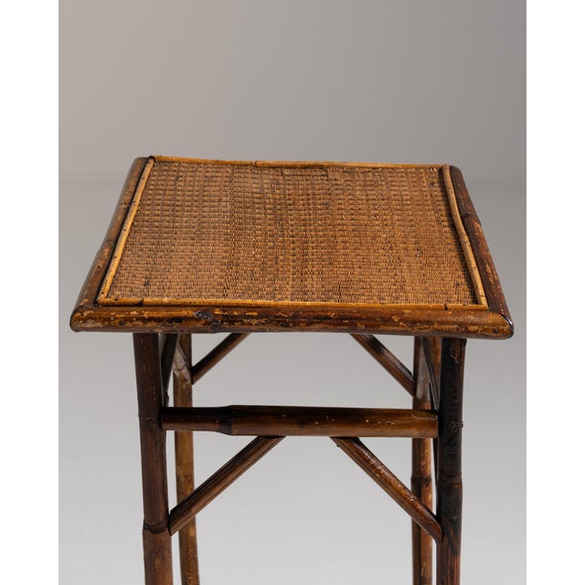 Faux-bamboo side table in Warm Honey Bamboo. Finished in warm honey bamboo, this faux-bamboo side table is distinguished...