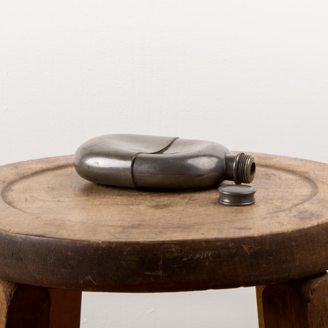 This antique military flask has a con caved center. Welded from two solid pieces, this flask can really withstand being in...