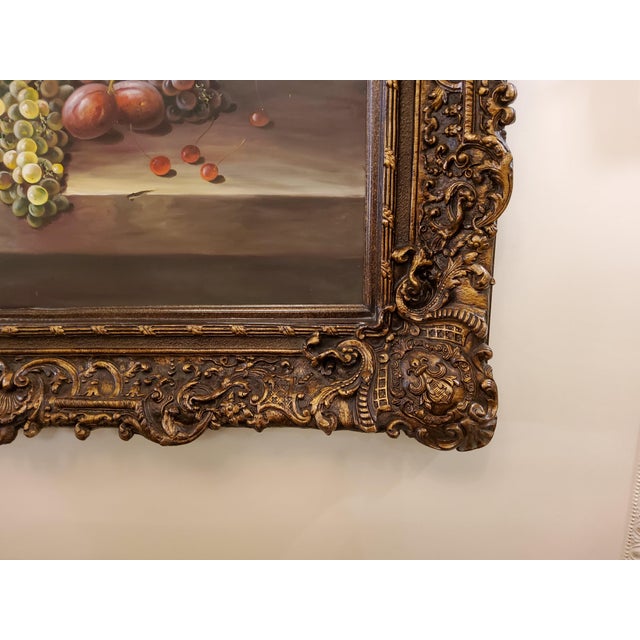 Hand painted art painted on canvas showing fruits displayed on a dish, with lively and sharp colors. The art is framed...