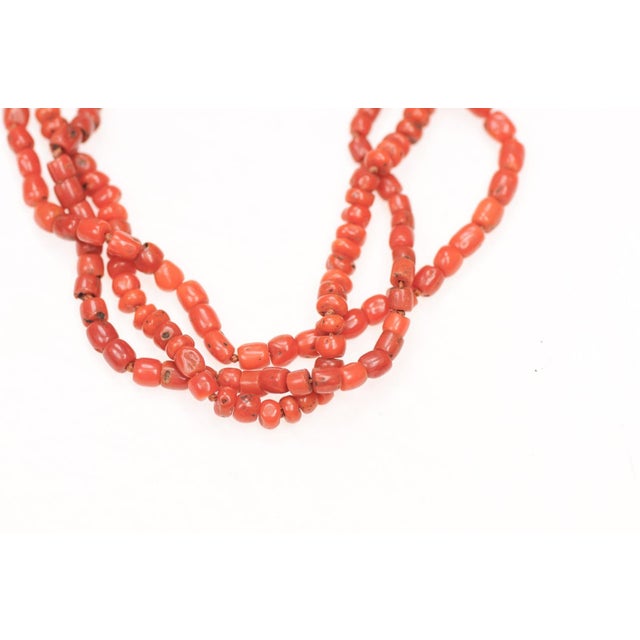 A short length three-strand antique coral beaded necklace from Morocco. The full length of the necklace is 17.75",...
