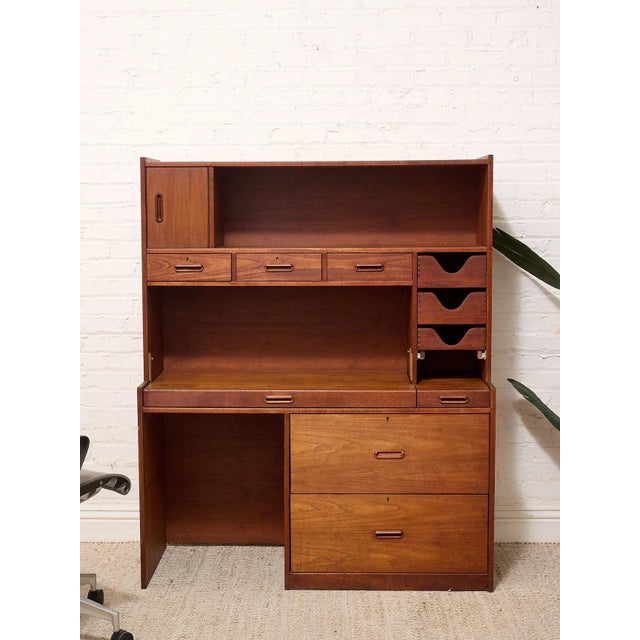 A beautifully functional vintage secretary desk with warm teak tones and a wonderfully architectural mid-century...