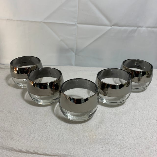 These vintage Mid-Century Modern roly-poly glasses feature a distinct rounded, bulbous shape and a striking metallic...
