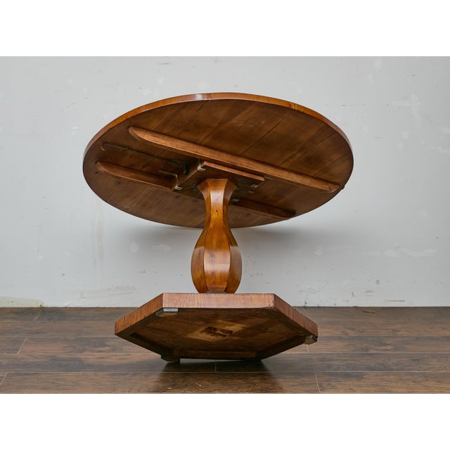 This early 19th-century Austrian Biedermeier center table presents an elegant balance of architectural restraint and rich...