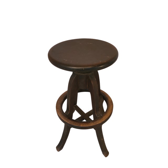 This is an antique oak adjustable height stool from the early 20th century. It's in perfect working order with the wear...