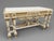 A refined 1970 French Louis XVI–style center table, handcrafted in solid beechwood and finished in a soft antique cream...