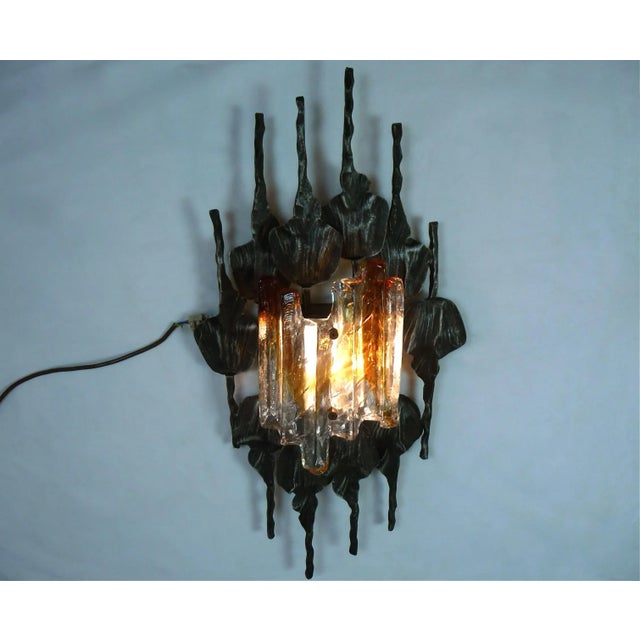 This brutalist sconce was manufactured in the 1960s. The lamp is made from hand-wrought anthracite grey iron and ice...