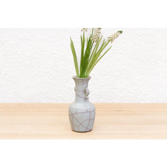 A splendid miniature Ge-type crackle vase. Its soft, pale glaze, adorned with the mesmerizing 'golden thread and iron...