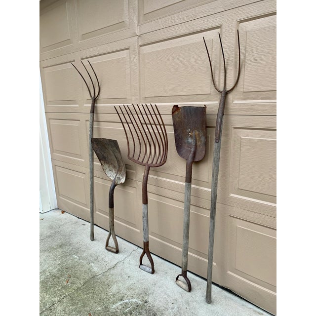 A beautiful set of five antique wooden & iron hand made garden tools. These would be ideal for an installation on a large...