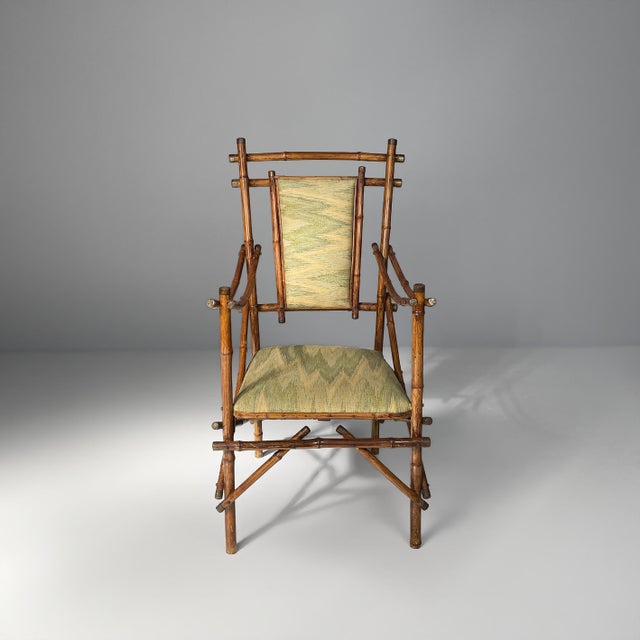 Italian art deco armchairs in fabric and bamboo, 1930s Pair of armchairs with dark brown bamboo frames, characterized by...