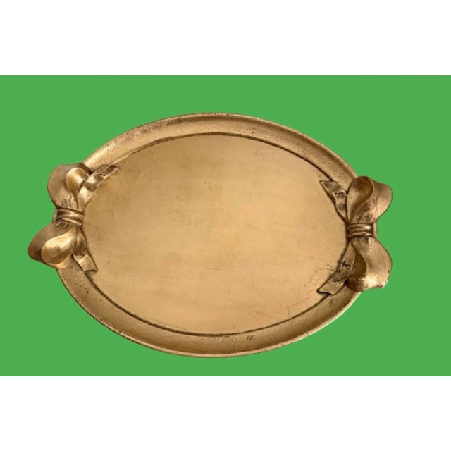 Great vintage Italian wood tray with gold leaf finish and beautiful bows for handles. Perfect to display your favorites...