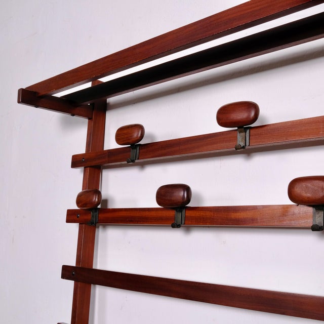 Dark-stained wood wall-mounted coat rack designed by Carlo Enrico Longhi for Elam in the 1960s and 1970s. An iconic piece...
