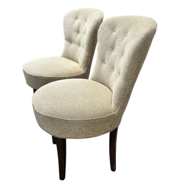 This is a matching pair of mid-century upholstered armless slipper side lounge chairs. They have button tufted backs, a...