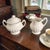 This Vintage English Ironstone J & G Meakin Classic White Sugar Bowl and Creamer Set is a timeless piece of porcelain...