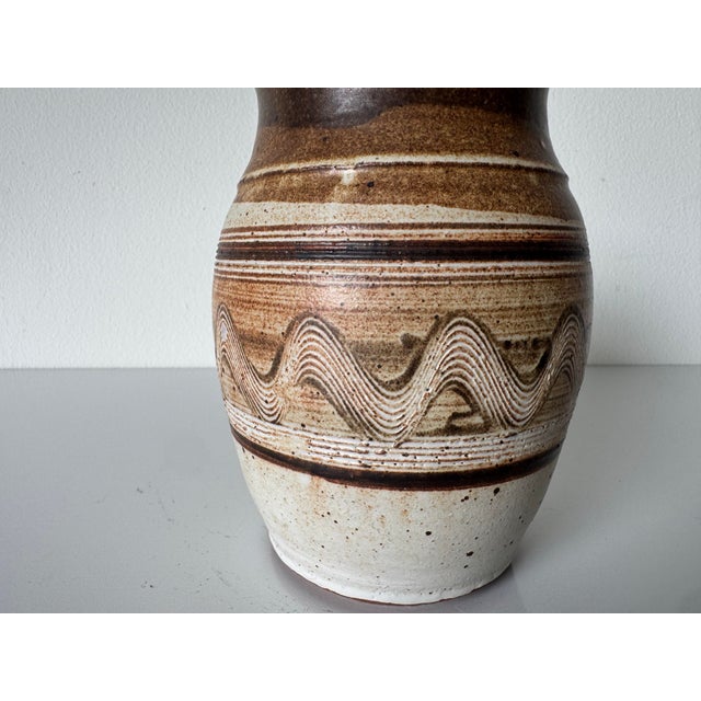 Beautiful vintage studio art pottery vase featuring an organic, hand-thrown form with rich earth-tone glazing. This piece...