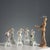 Group of five polychrome porcelain figurines depicting winged cherubs. Mark under the base. This piece is attributed to...