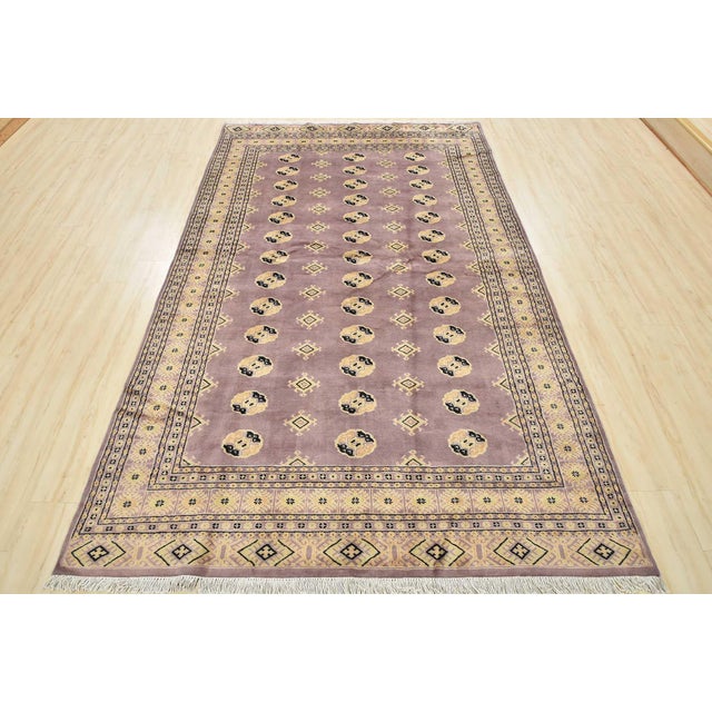 This traditional tribal Bokhara rug is hand-knotted with an all-wool pile on a cotton foundation. This rug is new and in...