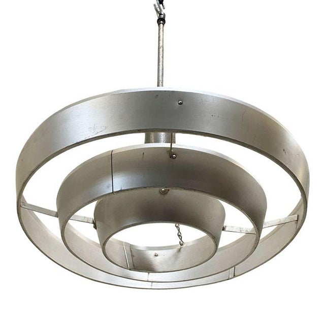 Kurt Versen designed the "Saturn" ceiling light featuring a stacked aluminum ring light shade suspended by wire to a...