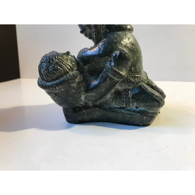 Intricate soapstone carving depicting two Eskimo children wrestling. Made in Canada during the 1970s by A Wolf/The Wolf...