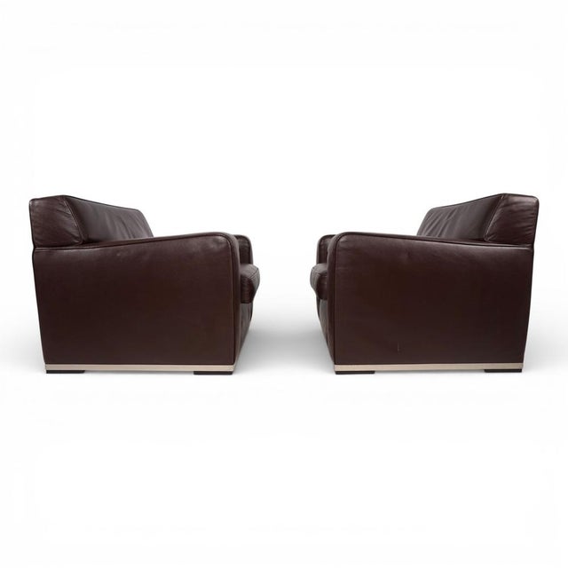 These two apta imprimatur leather armchairs in a warm brown leather tone are both in excellent condition. The leather...