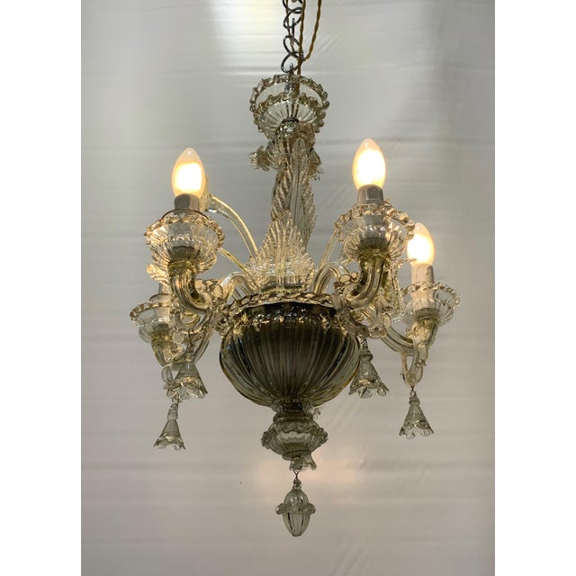Pendant lamp in clear glass with a smoked finish. elegant structure with richly detailed craftsmanship. slender central...