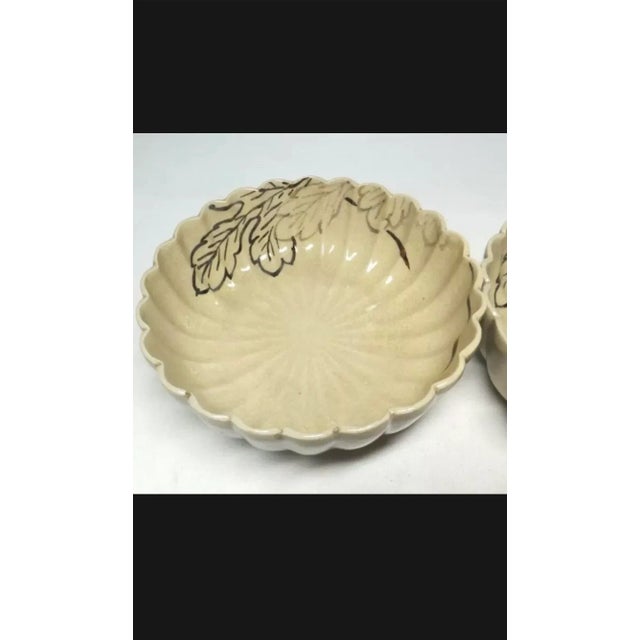 A pair of beautiful and unusual chrysanthemum-form bowls finely painted with oak leaves from the late Meiji, Early Taisho...