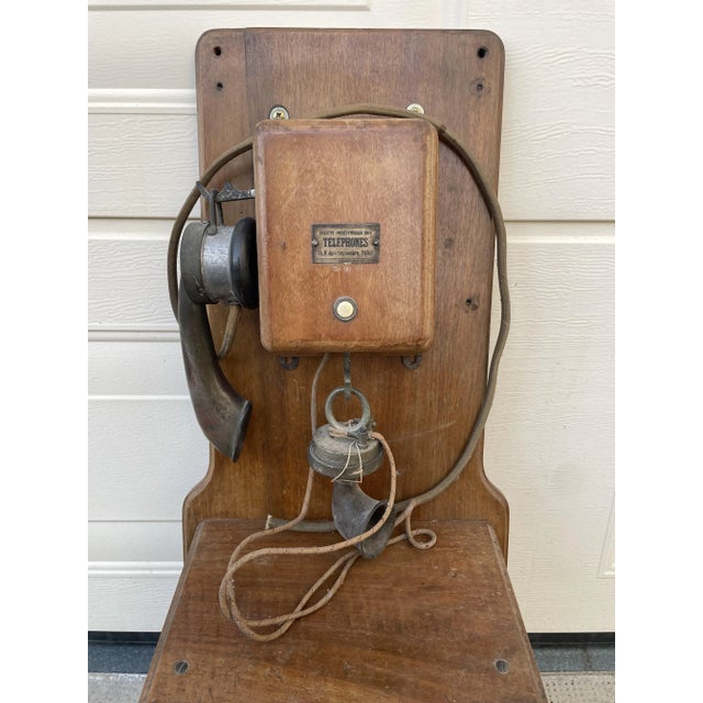 Antique wall-mounted telephone with handset, dimensions: 71 cm high, 30 cm wide, and 20 cm deep. 1900 model. Nicknamed...