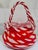 This striking vintage blown art glass handbag vase brings a pop of candy-apple red and creamy white to any shelf or...