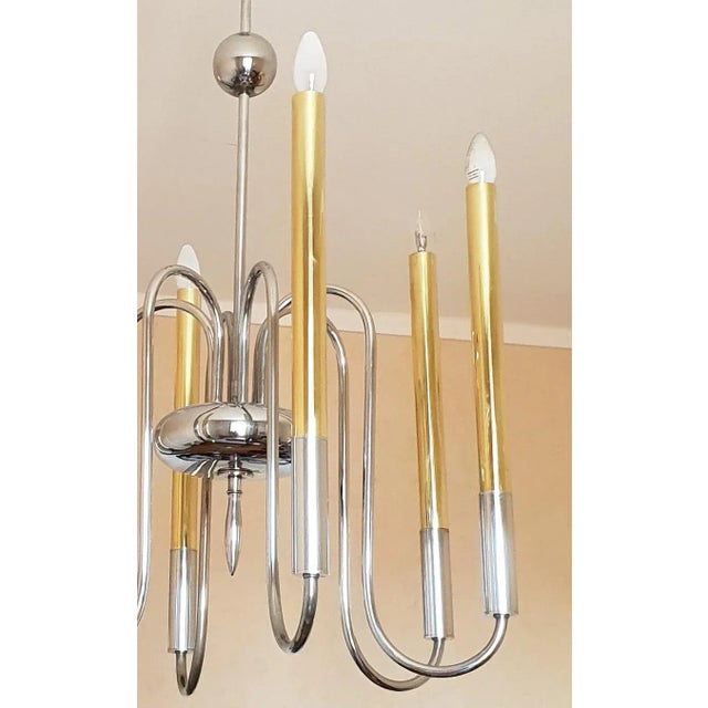 50s elegant silver-plated metal chandelier with a high shaft ringed at the centre of a sphere and supporting at the base a...