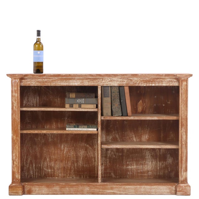A handsome open bookcase crafted in cerused oak, showcasing the understated elegance and textural appeal characteristic of...