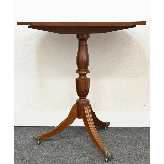 19th Century Antique Rectangular Tilt Top Table. It is mahogany table on a three footed hoof motif with brass casters. Has...