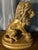 A striking vintage classical-style lion sculpture, crafted in resin with a warm antiqued gold gilt finish. This regal lion...
