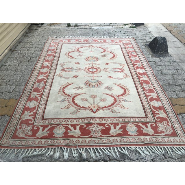 This is a vintage Turkish Oushak rug from the 1960s. The piece was hand-knotted.