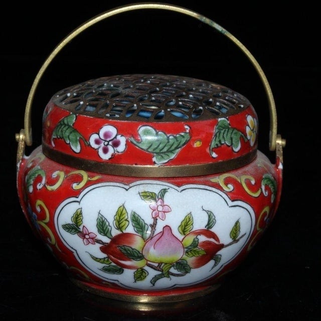 This is a finely crafted antique cloisonné enamel hand warmer or incense burner, a traditional object used for warmth or...