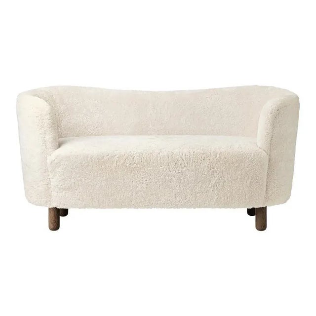 Off white sheepskin and smoked oak mingle sofa by Lassen Dimensions: W 154 x D 68 x H 74 cm Materials: Sheepskin, oak. The...
