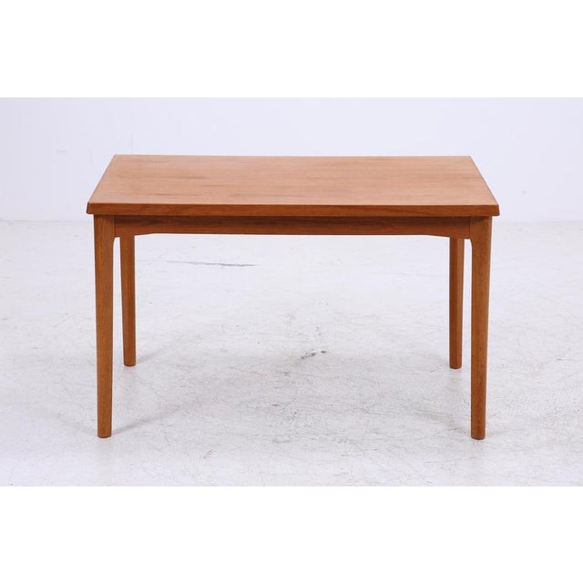 Beautiful vintage teak dining table from the 1960s with a clean, straight design and a calm, even grain. Extendable and...