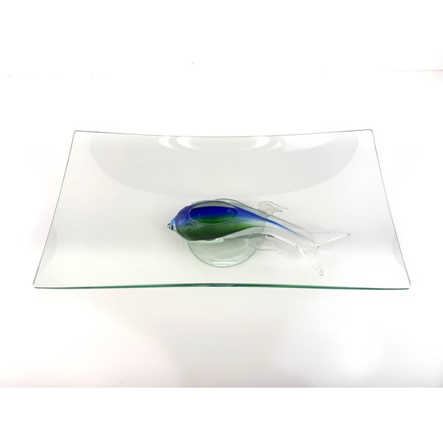 Vintage art glass centerpiece bowl featuring a sculptural fish form supporting a gently curved clear glass platter. The...